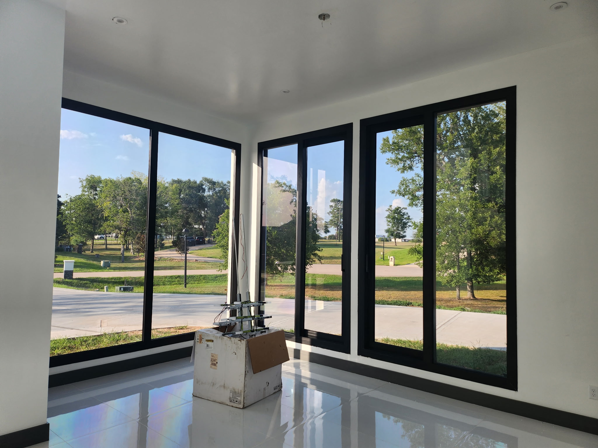 Large luxury estate Houston with dark window tint on arched and rectangular windows — exterior view